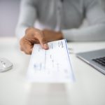 Someone offering a paycheck, a part of financial planning that some young people avoid.