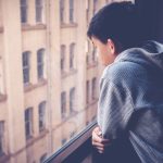 A lonely man in a window feeling left out