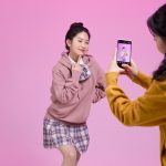 A woman posing as she is in a TikTok video