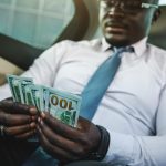 A rich person with his cash, showing a millionaire mindset