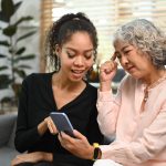 A grandmother with her daughter doing one of the things that grandparents do that offend modern parents