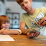 A father teaching his young child wealth secrets that are usually kept hidden