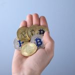 A man holding a collection of crypto coins