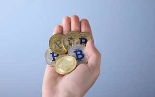 A man holding a collection of crypto coins
