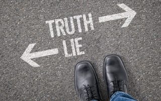 Truth/Lie written on concrete