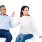 A woman looking away from a man who is being condescending