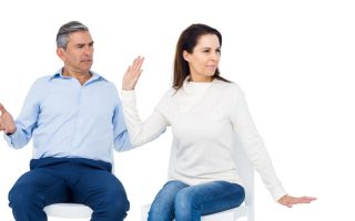 A woman looking away from a man who is being condescending