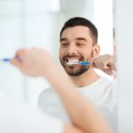 A man brushing his teeth, which is a personal hygiene practice that is good for you