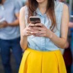 A young woman using her phone in the family group chat
