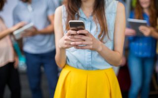 A young woman using her phone in the family group chat