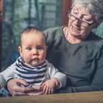 A grandparent babysitting her grandchild