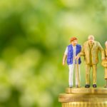 Model family on a stack of coins, symbolizing generational wealth