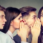Four people gossiping, possibly at work