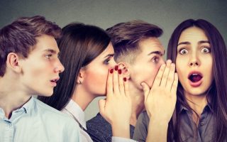Four people gossiping, possibly at work