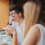 A man feeling judged in a conversation with a woman