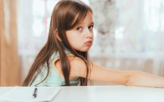 A young girl looking like she is feeling guilt