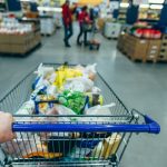 Someone buying in bulk at the store, which is an element of smart spending