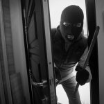 A criminal performing a home break in