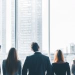 A group of business people looking out a window