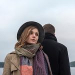 A woman who doesn't appreciate the presence of the man standing behind her