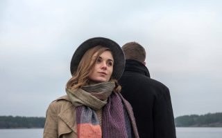 A woman who doesn't appreciate the presence of the man standing behind her