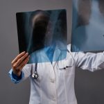 A medical professional looking at X-ray results