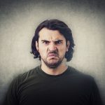 An angry man looking defensive