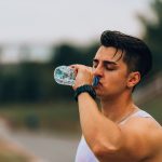 A man drinking water thinking it's good for his health