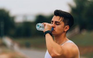 A man drinking water thinking it's good for his health