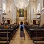 A woman standing in the middle of a church