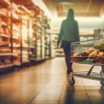 A woman wandering down a grocery store aisle