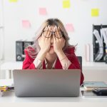 An office worker feeling the stress of modern social norms