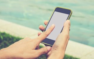 Someone using a smartphone that could be harvesting data