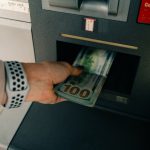 Pulling money out of an ATM after a banking scandal and rebranding