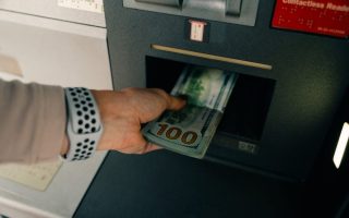 Pulling money out of an ATM after a banking scandal and rebranding