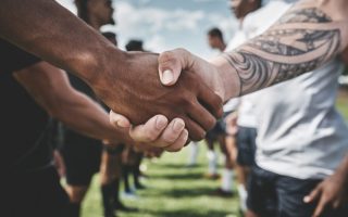 Men shaking hands to be the peacemaker