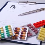 Prescription drugs and a doctor's clipboard