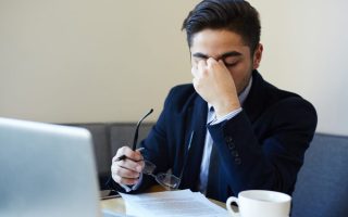 A man looking stressed and passive-aggressive at work
