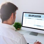 A man filing out a job application online